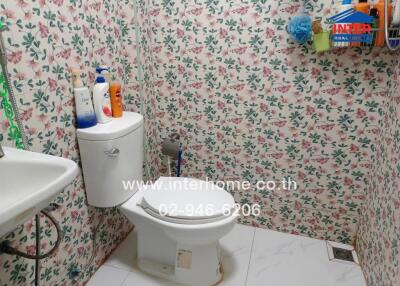 Bathroom with floral wallpaper and toilet