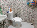 Bathroom with floral wallpaper and toilet