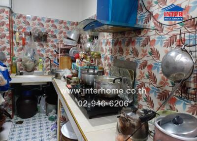 Small kitchen with various cooking utensils and appliances