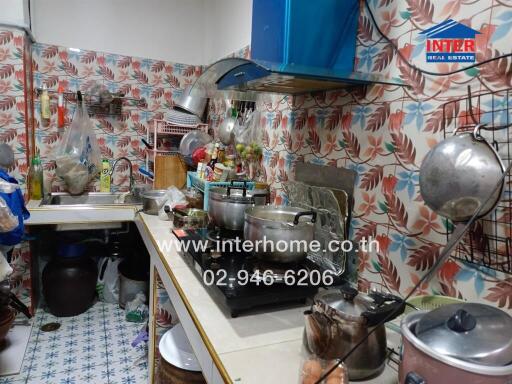 Small kitchen with various cooking utensils and appliances