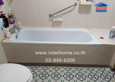 Bathroom with bathtub and patterned floor