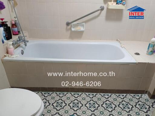 Bathroom with bathtub and patterned floor