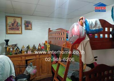 Small bedroom with bunk beds and religious decorations