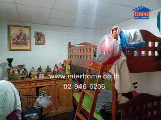 Small bedroom with bunk beds and religious decorations