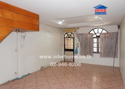 Living room with tiled flooring and wooden accents