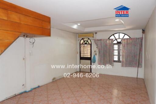 Living room with tiled flooring and wooden accents