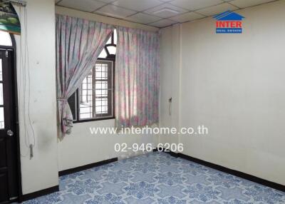 Empty room with curtains, tiled floor, and window