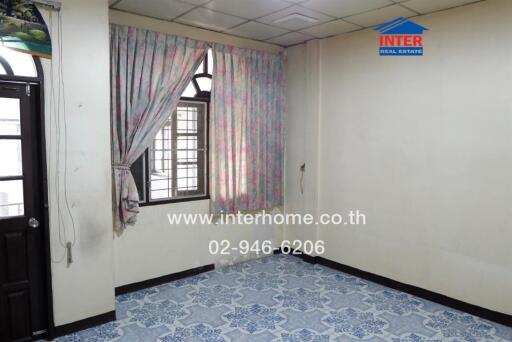 Empty room with curtains, tiled floor, and window