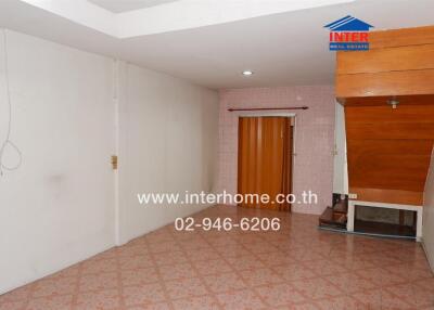 Open area with tiled floor and wooden accents