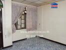 Empty bedroom with floral curtains and tiled floor