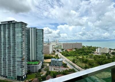 View of high-rise buildings and coastline from balcony