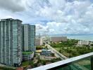 View of high-rise buildings and coastline from balcony