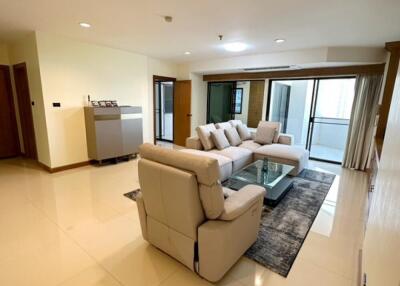 Spacious living room with comfortable seating and glass coffee table