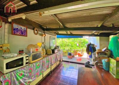 A brightly lit kitchen with a large window and various appliances