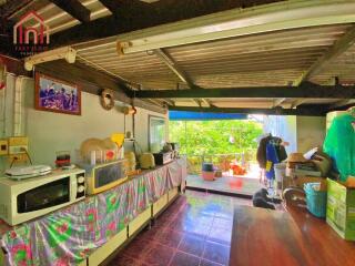 A brightly lit kitchen with a large window and various appliances