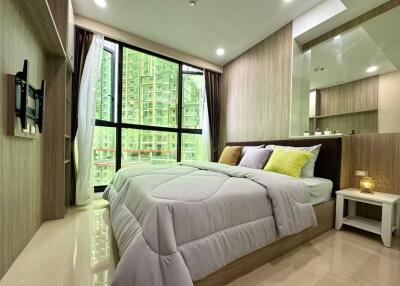 Modern bedroom with large window and urban view