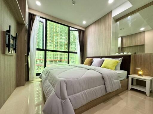 Modern bedroom with large window and urban view