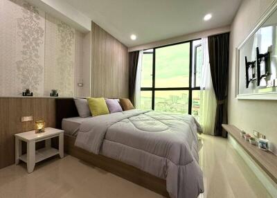 Modern bedroom with large window and city view