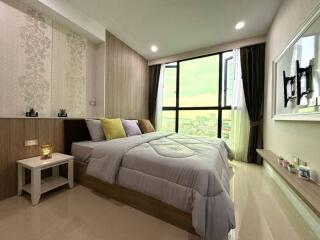 Modern bedroom with large window and city view