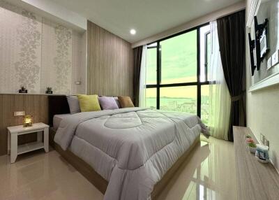 well-furnished bedroom with large window view