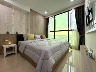 well-furnished bedroom with large window view