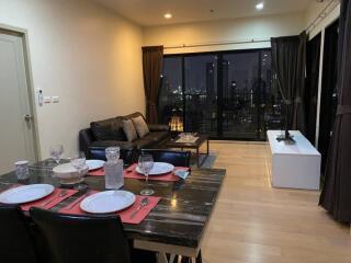 Modern living room with dining area and city view