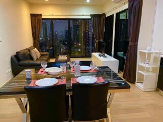 Modern living room with dining area and city view