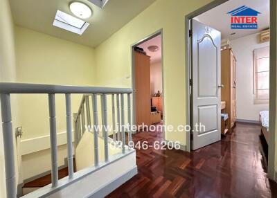 Upper floor hallway with wooden flooring