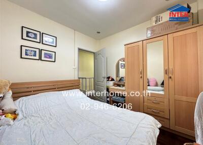 Cozy bedroom with wooden furniture and decorations