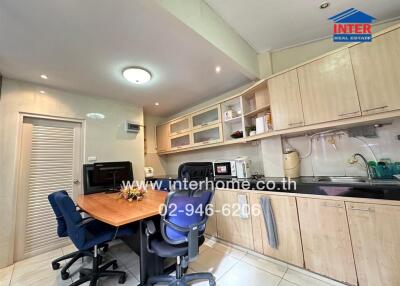 Modern kitchen with wooden cabinets and dining space