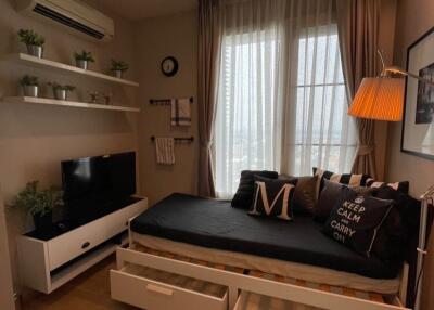 Cozy bedroom space with daybed, TV, and storage