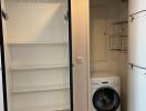 Laundry room with washer and open shelving