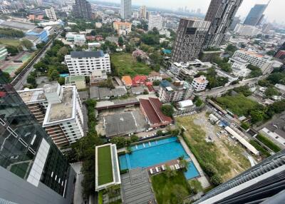 Aerial view of urban area with buildings, greenery, and a swimming pool