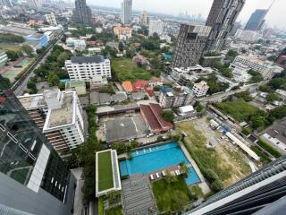 Aerial view of urban area with buildings, greenery, and a swimming pool