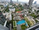 Aerial view of urban area with buildings, greenery, and a swimming pool