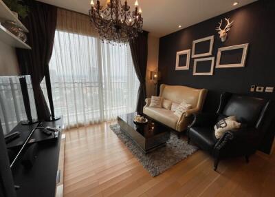 Cozy living room with chandelier and large window