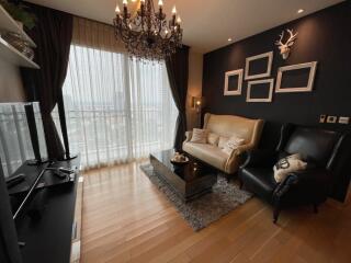 Cozy living room with chandelier and large window