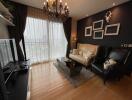 Cozy living room with chandelier and large window