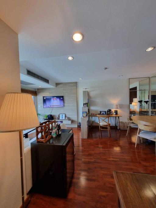 Spacious and modern living area with hardwood floors and ample natural lighting