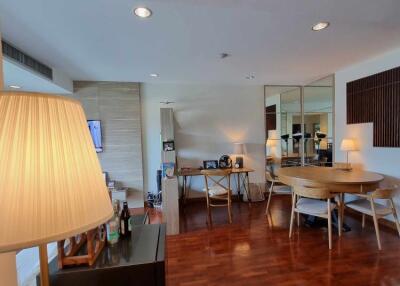 spacious main living area with wooden floor, large window, and modern furnishings