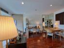 spacious main living area with wooden floor, large window, and modern furnishings