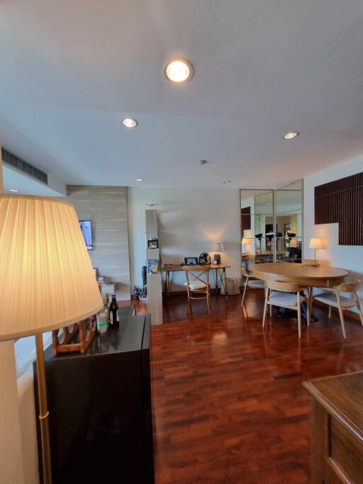 spacious main living area with wooden floor, large window, and modern furnishings