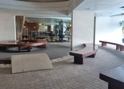 Indoor public space with seating area and view of gym