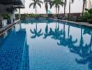 Swimming pool with palm trees and surrounding greenery