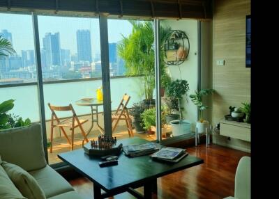 Modern living room with city view and access to balcony