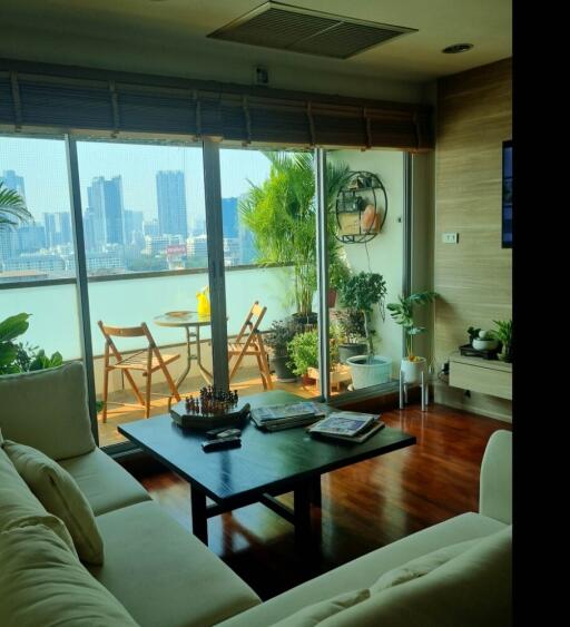 Modern living room with city view and access to balcony