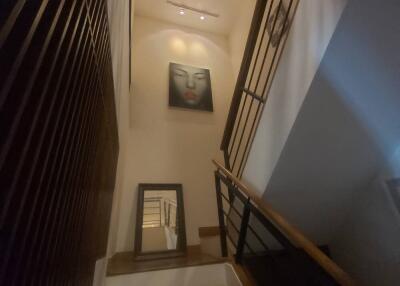 Staircase with framed artwork and mirror