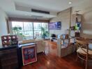 Modern living room with wooden flooring and large windows