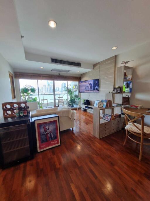 Modern living room with wooden flooring and large windows