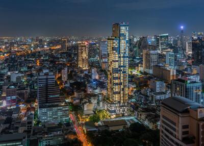 Aerial view of a cityscape at night showcasing various buildings and illuminated streets